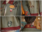Knock Thrice x Rusty Quill, black fall/spring button-up cotton jacket. The jacket features both embroidered and patchwork OIAR themed elements, in red, and green.