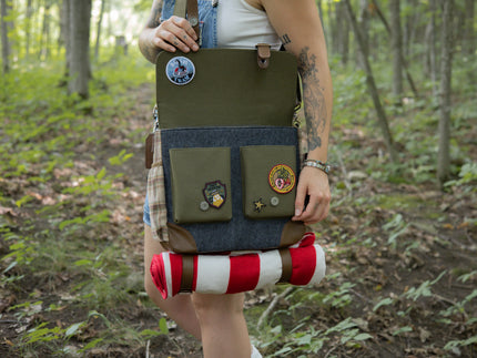 Brown and green messenger style bag in 100% cotton canvas outer and flannel lining. The bag included an adjustable shoulder strap, blanket straps, laptop pocket, and real leather corners.