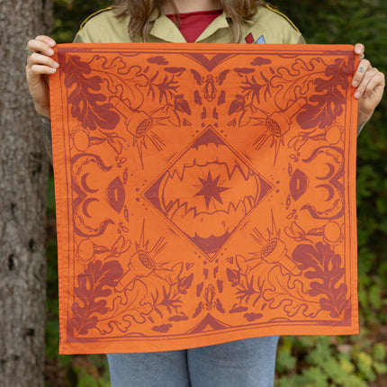 Orange and burgundy 100% cotton reversible bandana measuring 21.5 x 21.5 inches // 54x54 cm, with printed details.