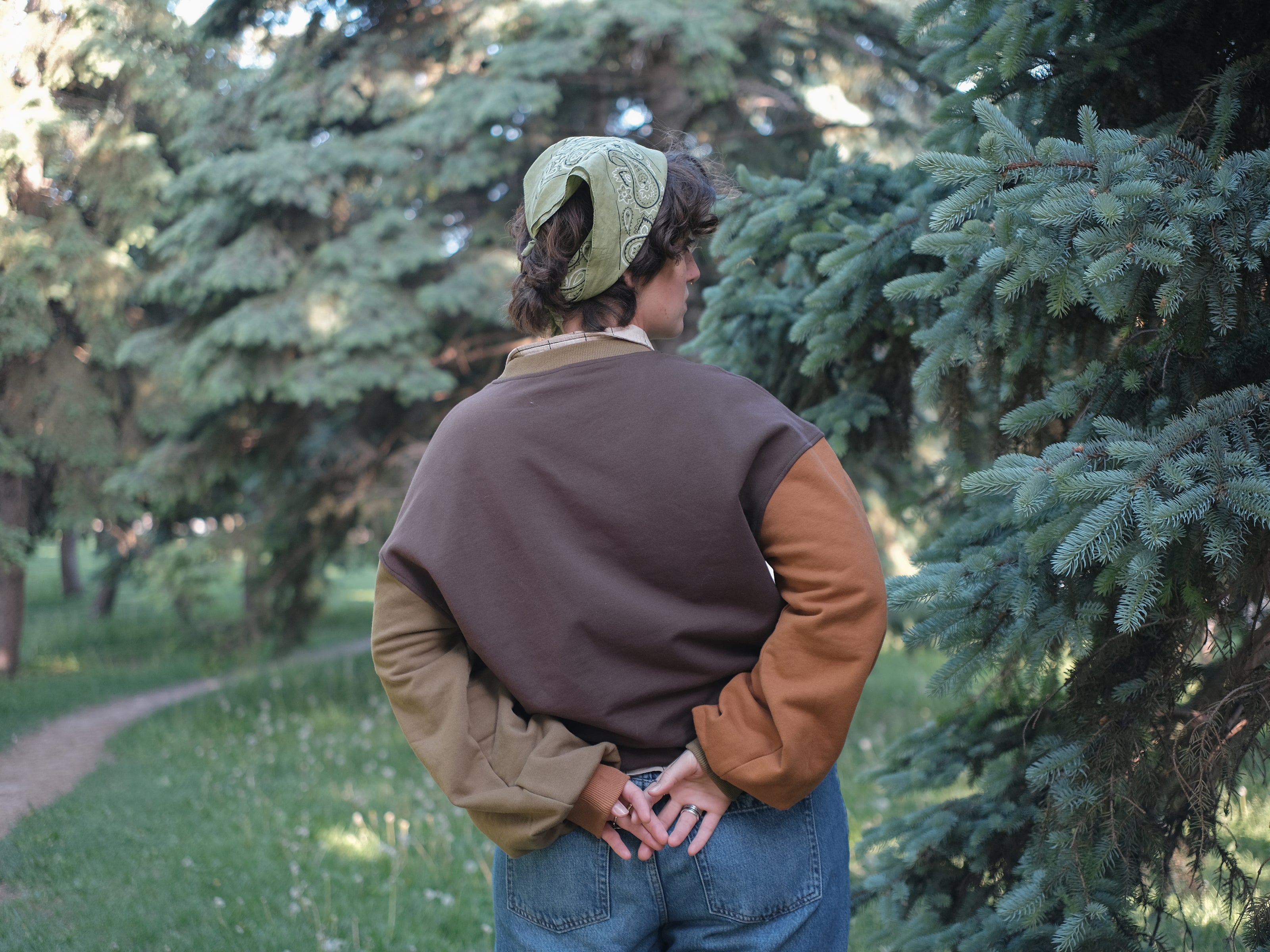 Cozy, oversized, puff-sleeved, cotton crewneck sweater in pumpkin-orange and shades of brown. The sweater features an intricately embroidered design in white and orange, of a pumpkin skeleton, vines, stork scissors, and reads â€œDon Your Vegetablesâ€.