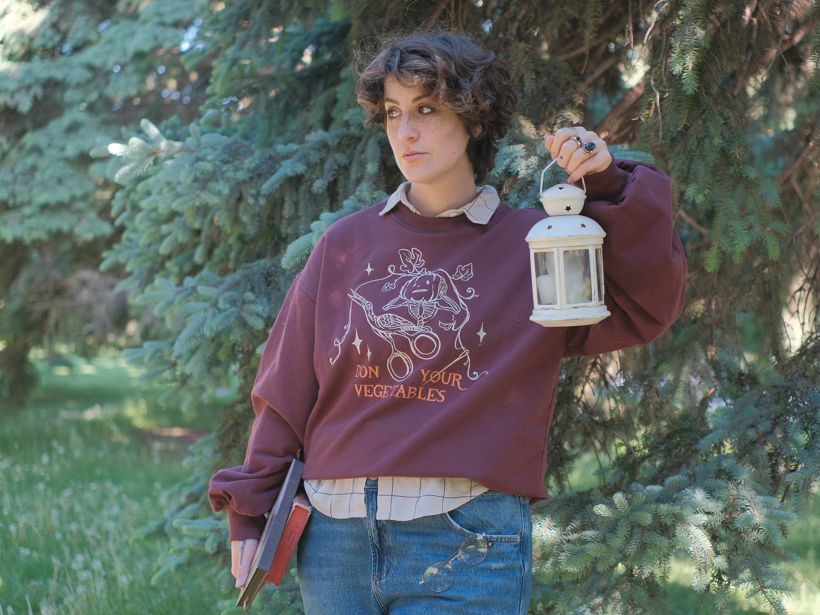 Cozy, oversized, puff-sleeved, cotton with fleece-lining, crewneck sweater in burgundy. The sweater features an intricately embroidered design in white and orange, of a pumpkin skeleton, vines, stork scissors, and reads â€œDon Your Vegetablesâ€.