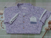 A muted purple, short-sleeve button up t-shirt printed with a whimsical pattern of fancy teacups, bergamot flowers, lavender sprigs, tea bags, spoons and sugar cubes. The shirt has a pyramid tea bag pocket, as well as a relaxed fit and rolled cuffs.