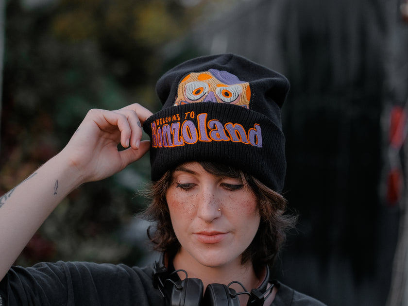 Knock Thrice x Rusty Quill â€œWelcome to Bonzoland!â€ black Knit Beanie from The Magnus Protocol. The beanie features Mr. Bonzoâ€™s happy face and hidden horrors beneath the brim. Ribbed band with â€˜Welcome to Bonzolandâ€™ embroidery.