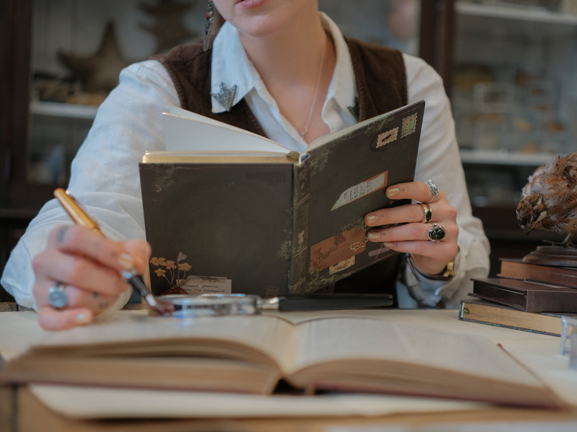 A vintage-style green notebook titled 