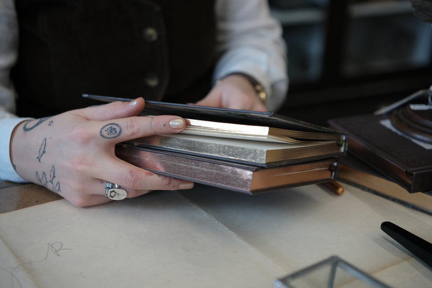 A vintage-style green notebook titled 