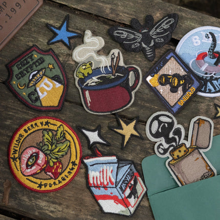 Cryptid and camp themed embroidered patch set, made with 100% polyester threads.