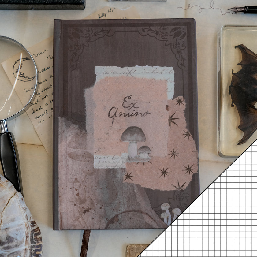 A dark mauve notebook with copper gilded edges, a satin reading ribbon and vintage design, titled 