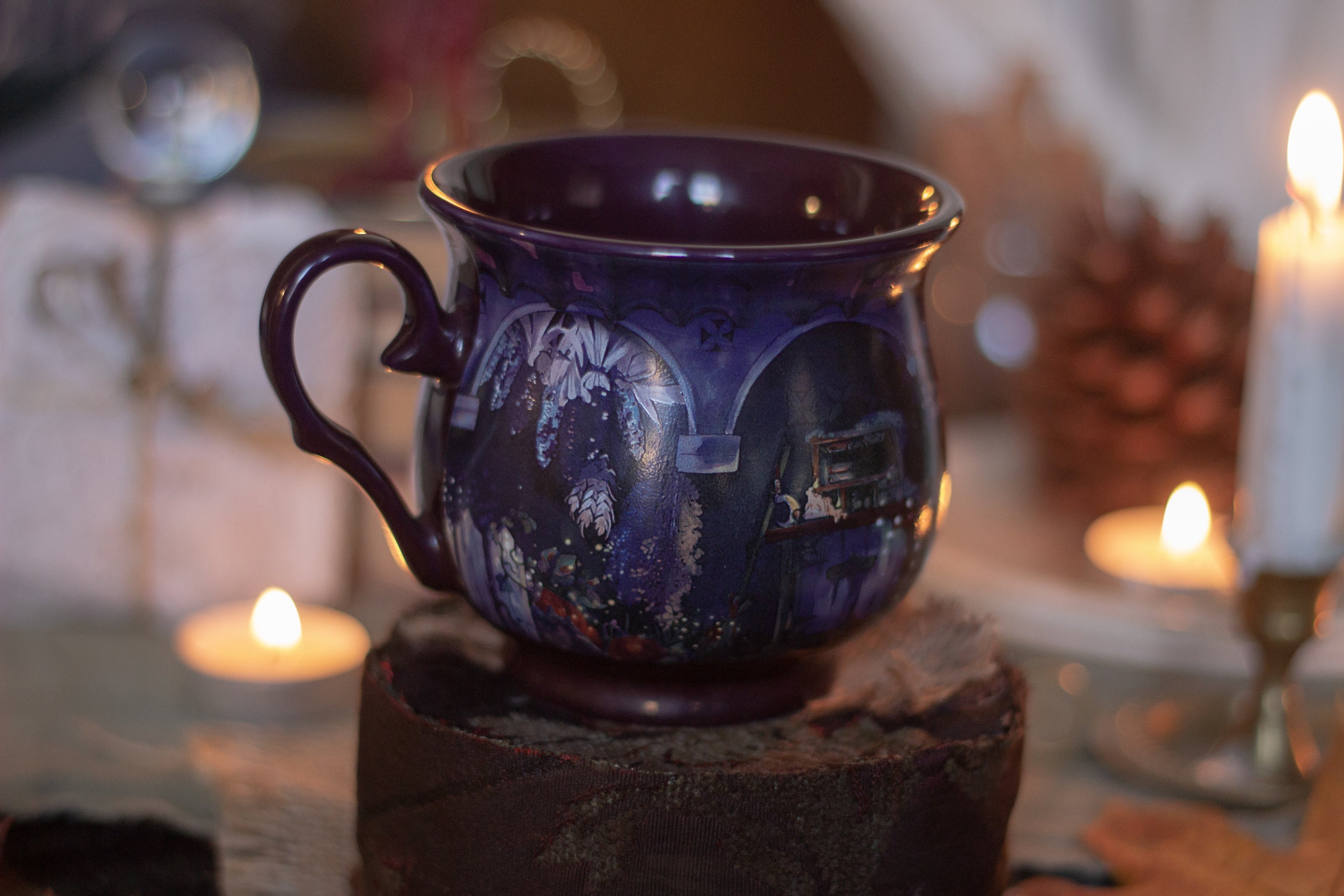 Deep plum-purple, heat-sealed 360Â° printed mug of a witchâ€™s cottage at night, featuring a mystical design with a glowing full moon, the forest glinting in the moonlight, a kitten rising for a midnight prowl, and an enchanting arched doorway. Microwave and dishwasher safe. They are a rounded shape with a wide lip, to keep your hands cozy all winter long.  
