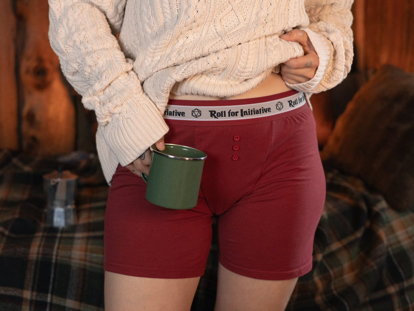 Knock Thrice Knoxers // red cotton, fitted boxers. The boxers are mid-high rise, and have a red and white spandex waistband that pictures a DnD dice and reads 