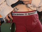 Knock Thrice Knoxers // red cotton, fitted boxers. The boxers are mid-high rise, and have a red and white spandex waistband that pictures a DnD dice and reads 