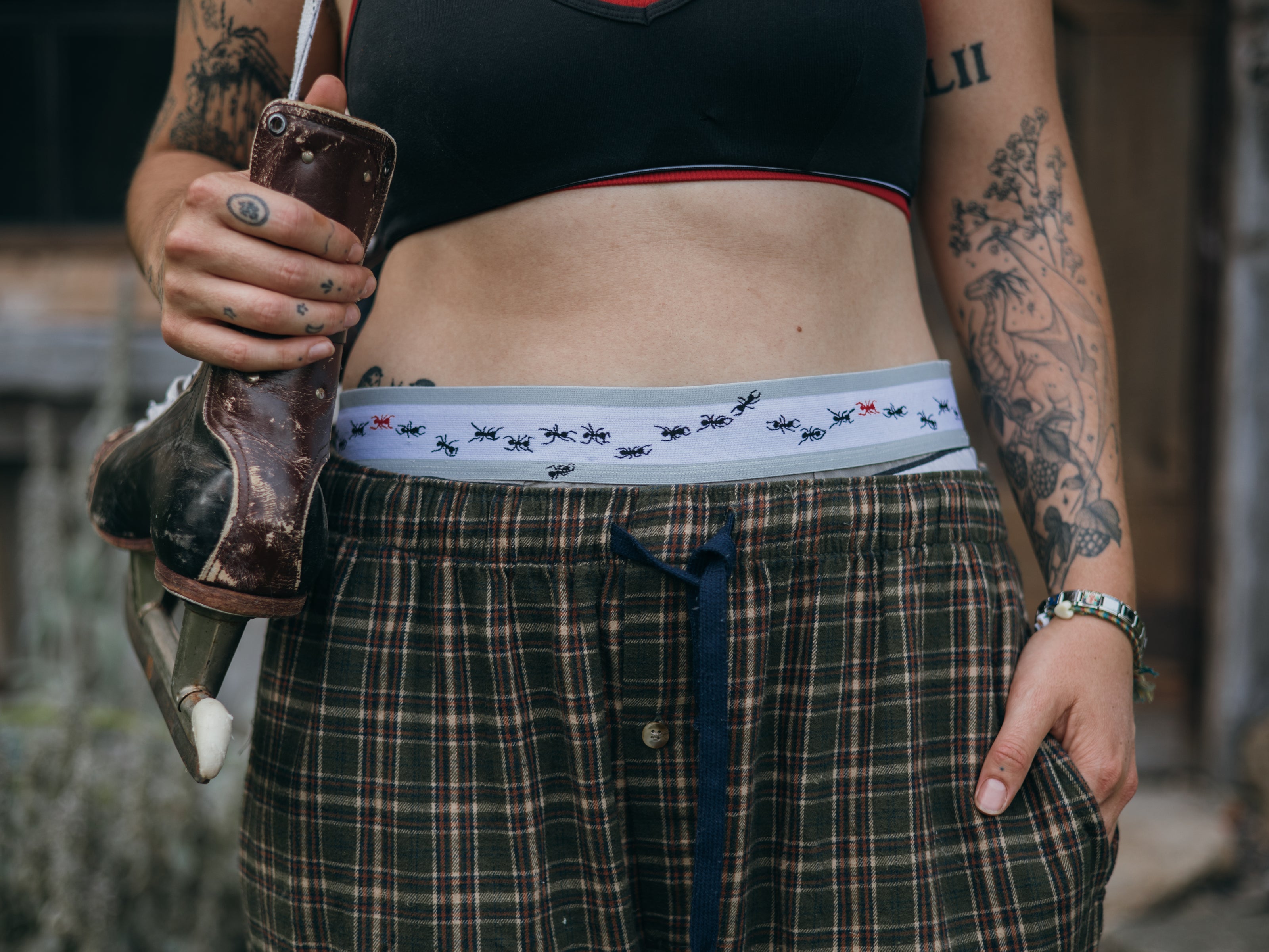 Knock Thrice Knoxers // white, black, and light olive green, striped cotton, fitted boxers. The boxers are mid-high rise,  and have a grey spandex waistband with black and red ants 