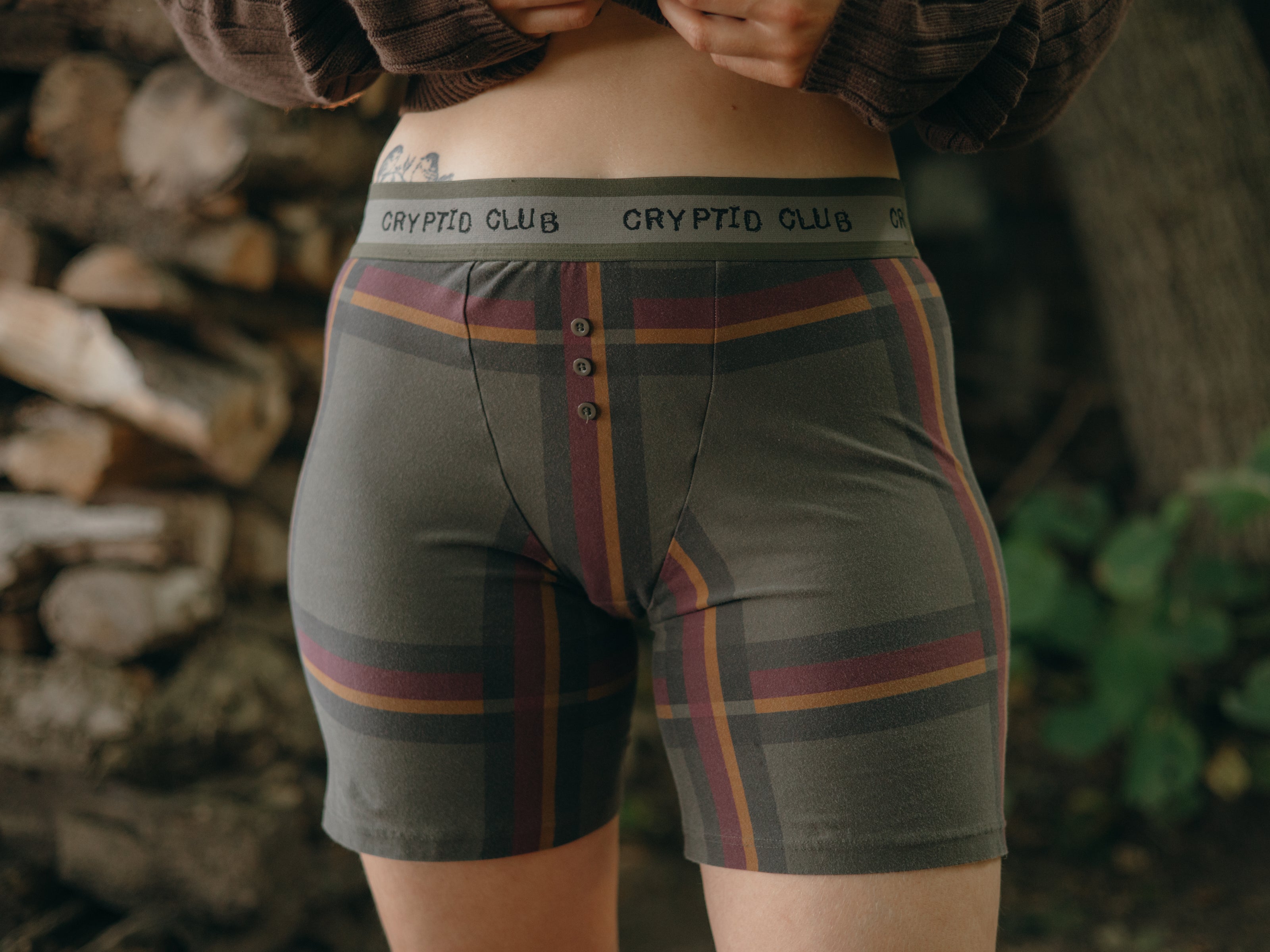 Knock Thrice Knoxers // burgundy, olive green, and mustard yellow plaid, cotton, fitted boxers. The boxers are mid-high rise,  and have a green and grey spandex waistband that reads 