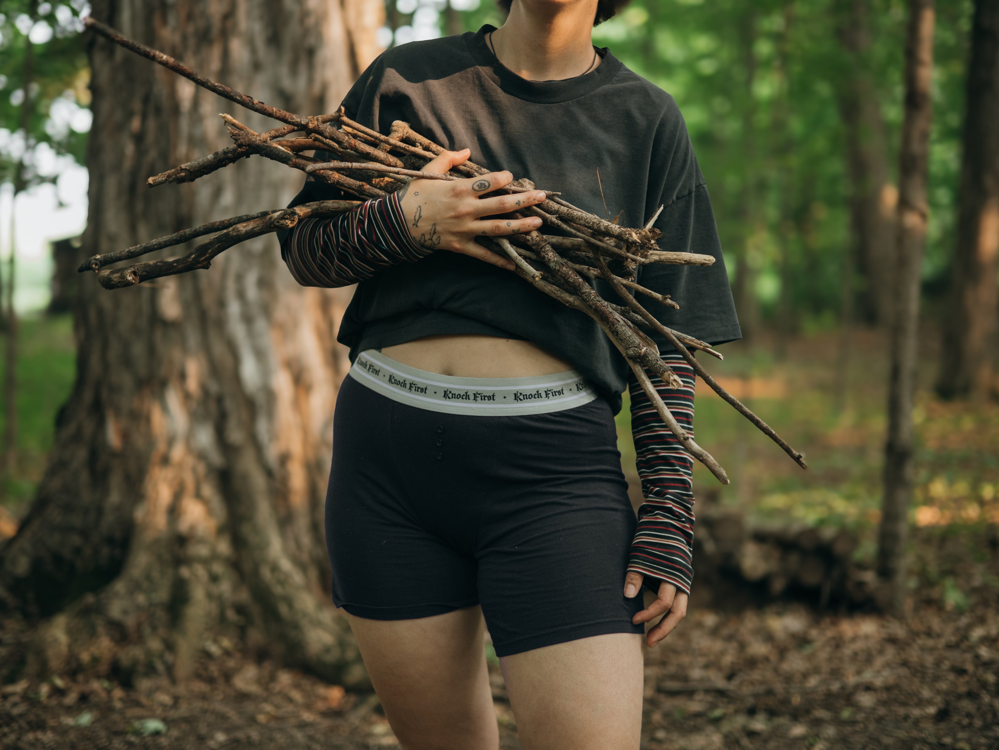 Knock Thrice Knoxers // black cotton, fitted, unisex boxer briefs. The boxers are mid-high rise,  and have a grey spandex waistband that reads 