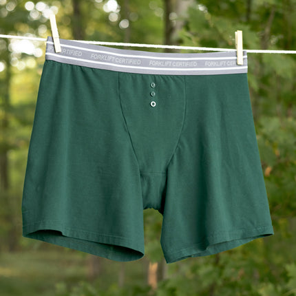 Knock Thrice Knoxers // forest green cotton, fitted boxers. The boxers are mid-high rise,  and have a grey spandex waistband that reads 