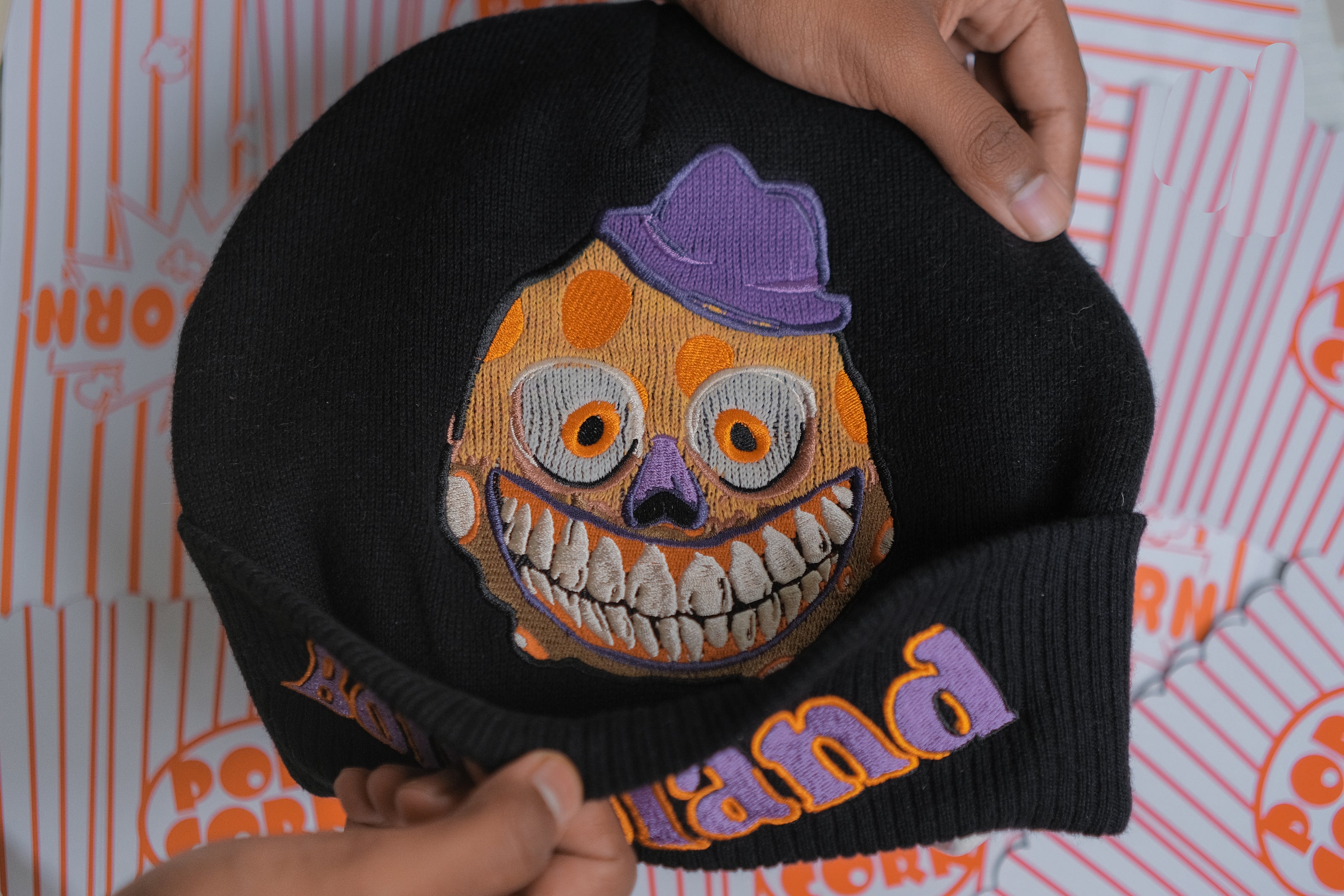 Knock Thrice x Rusty Quill â€œWelcome to Bonzoland!â€ black Knit Beanie from The Magnus Protocol. The beanie features Mr. Bonzoâ€™s happy face and hidden horrors beneath the brim. Ribbed band with â€˜Welcome to Bonzolandâ€™ embroidery.