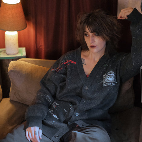 Magnus Protocol, oversized, knit-cardigan, in black. The cardigan is inspired by old cassette tapes, and features embroidered analog details, and the OIAR crest.