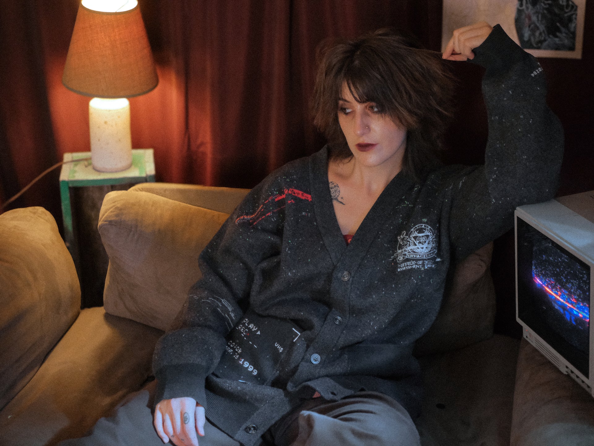 Magnus Protocol, oversized, knit-cardigan, in black. The cardigan is inspired by old cassette tapes, and features embroidered analog details, and the OIAR crest.