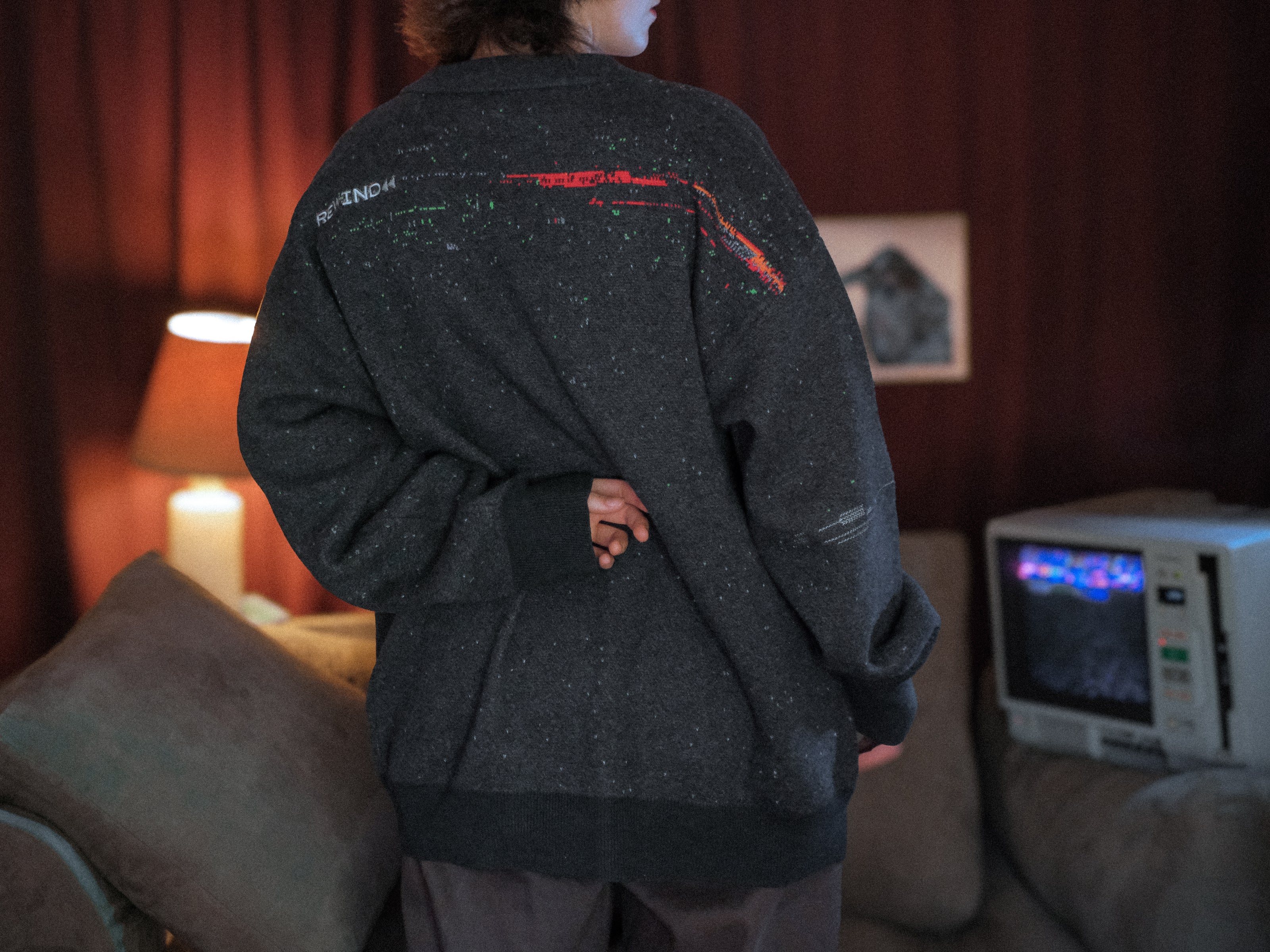 Magnus Protocol, oversized, knit-cardigan, in black. The cardigan is inspired by old cassette tapes, and features embroidered analog details, and the OIAR crest.