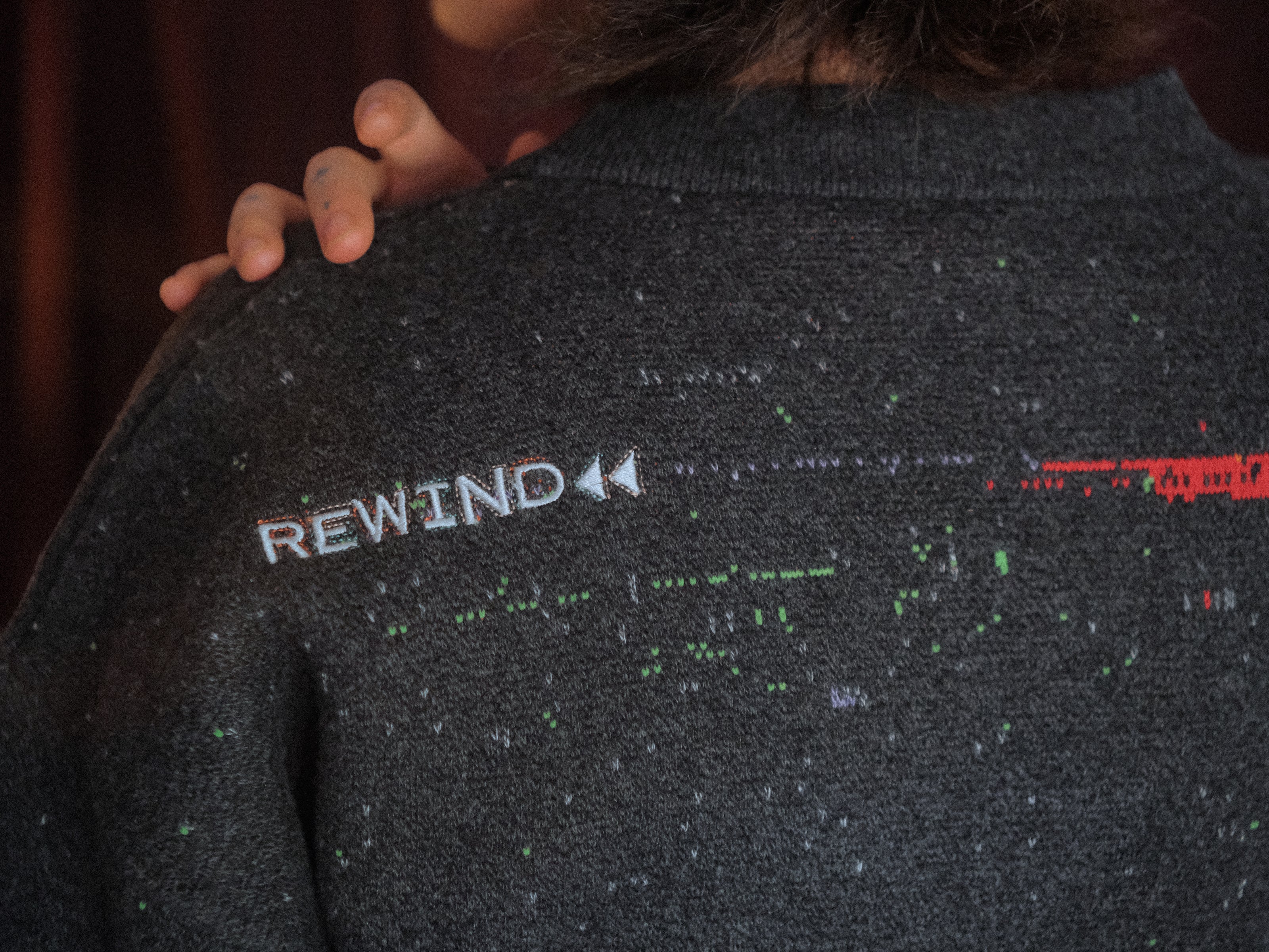 Magnus Protocol, oversized, knit-cardigan, in black. The cardigan is inspired by old cassette tapes, and features embroidered analog details, and the OIAR crest.