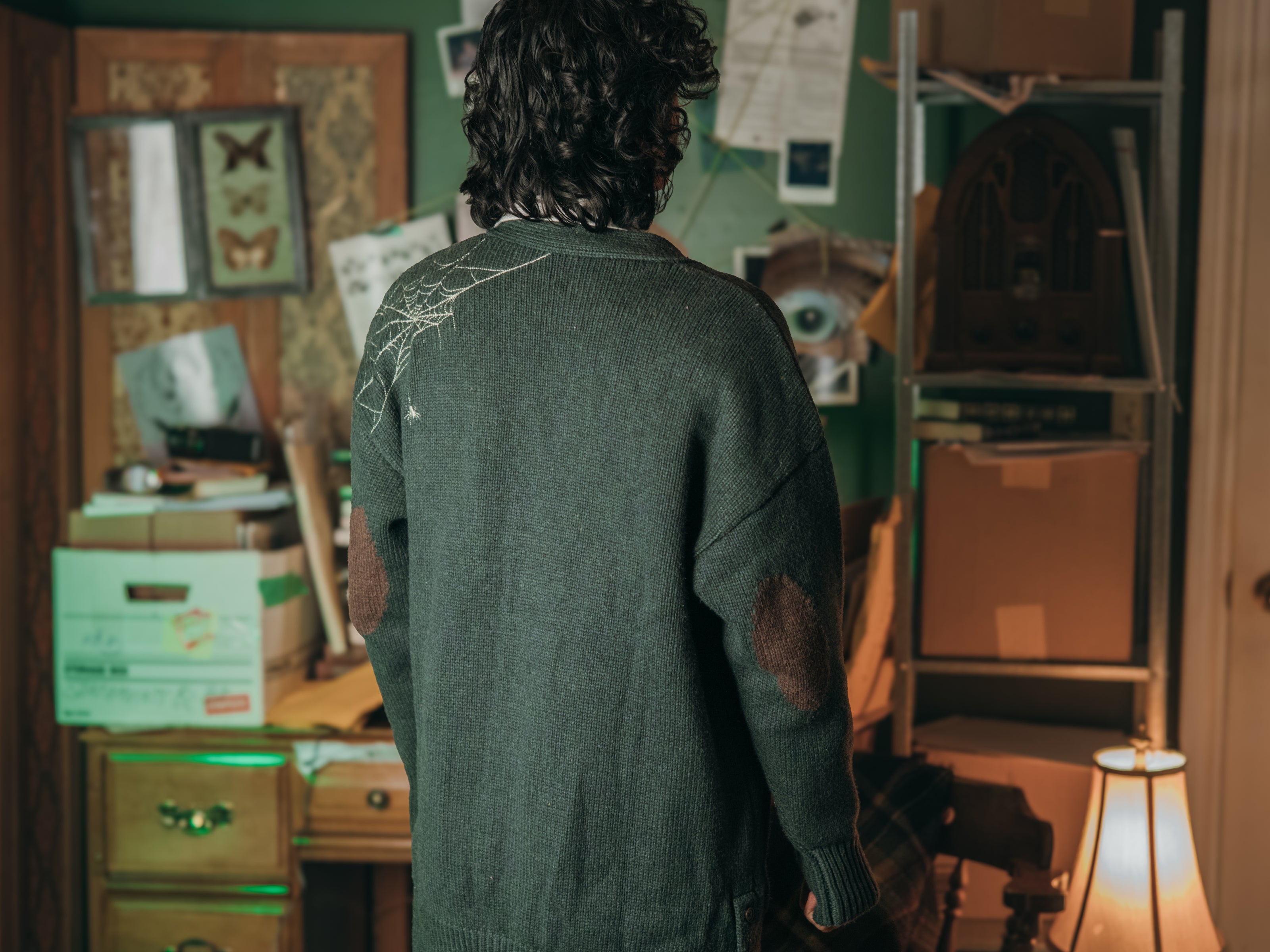 Magnus Archives x Knock Thrice oversized knit cardigan with embroidered details in dark green. Made of 60% Cotton 30% Nylon 10% Wool.