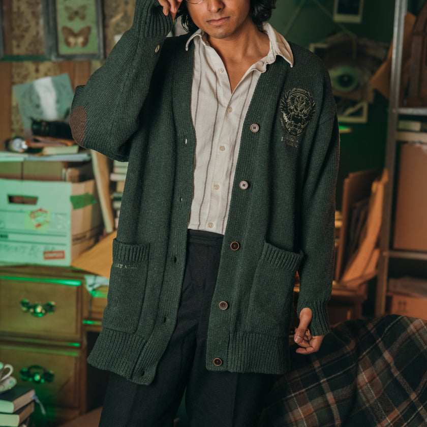 Magnus Archives x Knock Thrice oversized knit cardigan with embroidered details in dark green. Made of 60% Cotton 30% Nylon 10% Wool.