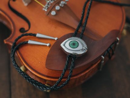 Magnus Archives x Knock Thrice adjustable, leather green-eye bolo tie, with silver details.