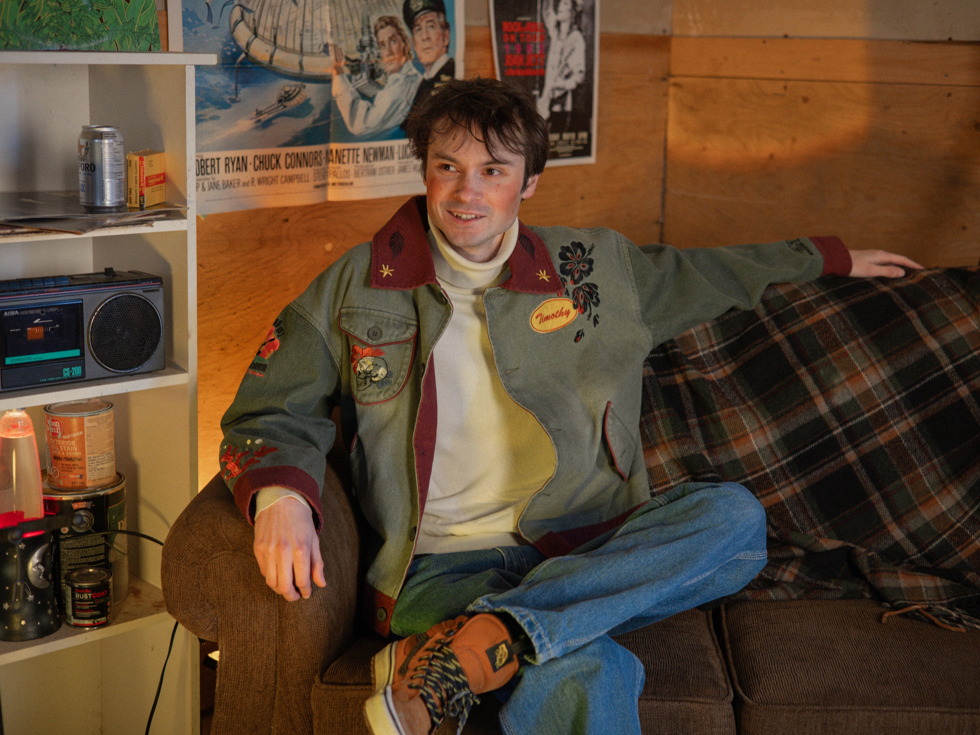 Knock Thrice x Rusty Quill, black fall/spring button-up cotton jacket. The jacket features both embroidered and patchwork OIAR themed elements, in red, and green.