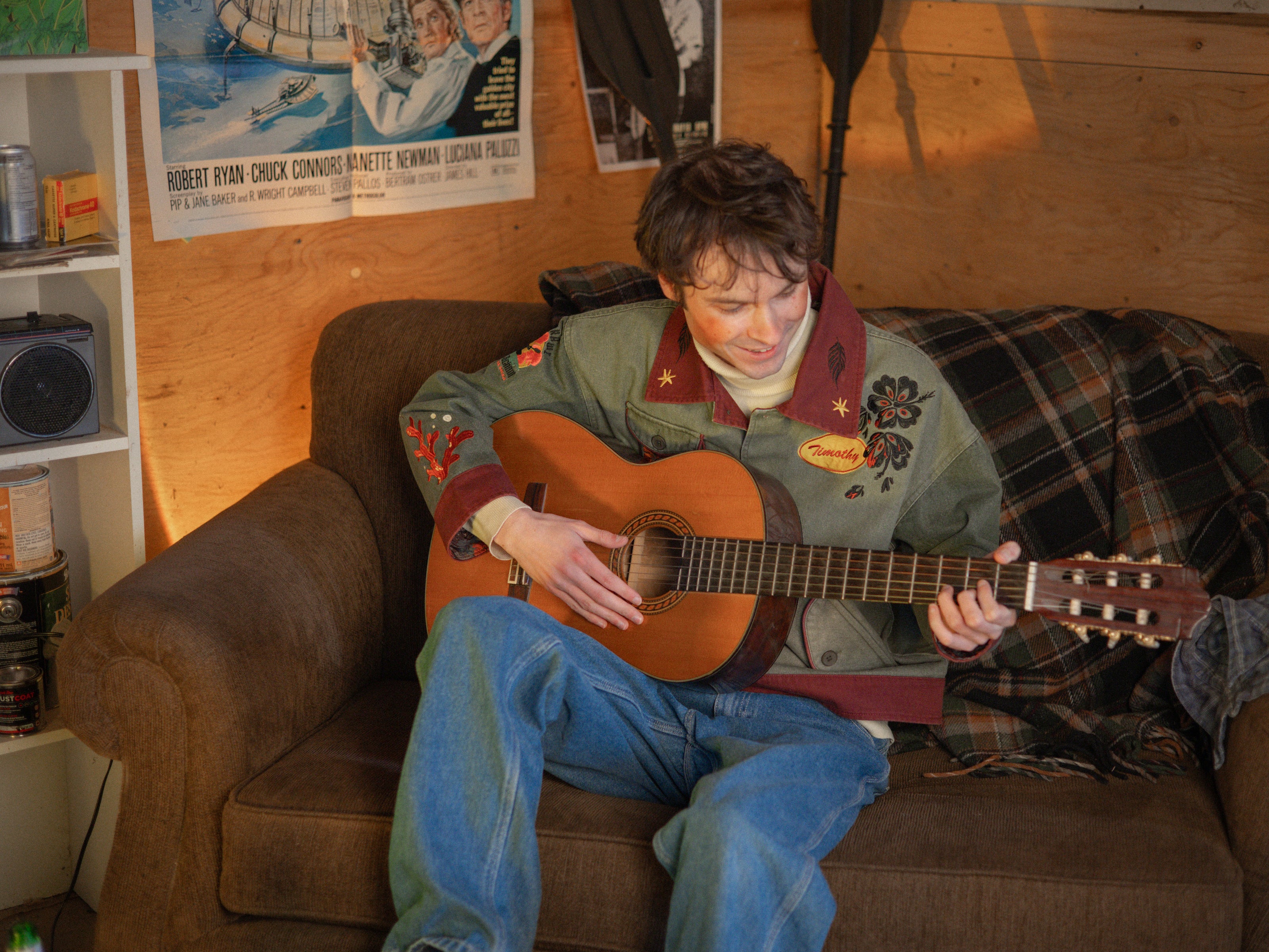 Knock Thrice x Rusty Quill, black fall/spring button-up cotton jacket. The jacket features both embroidered and patchwork OIAR themed elements, in red, and green.