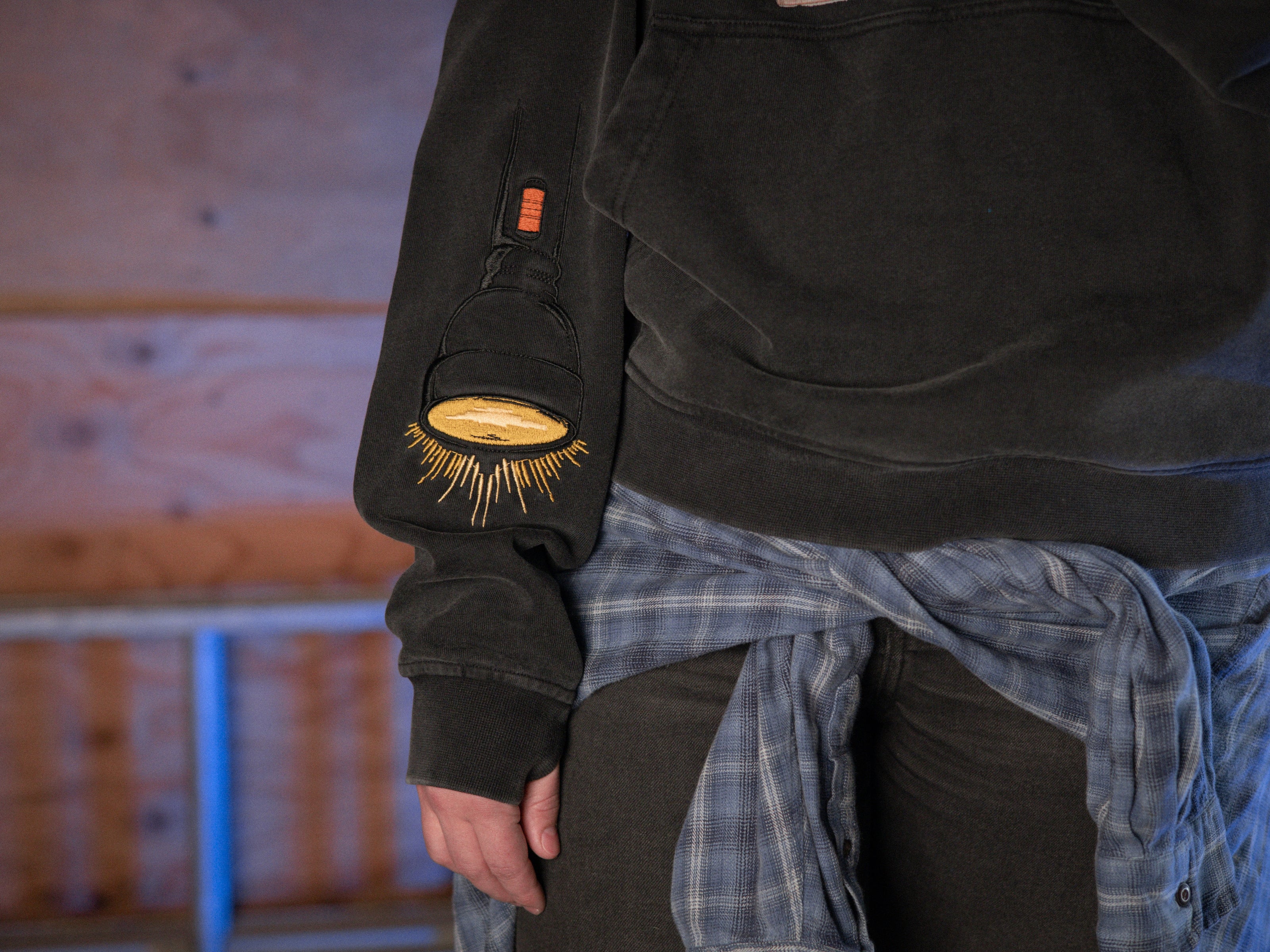 Rusty Quill X Knock Thrice 100% cotton hoodie in black, with a boxy, oversized, slightly cropped fit. The hoodie features both printed and embroidered details.