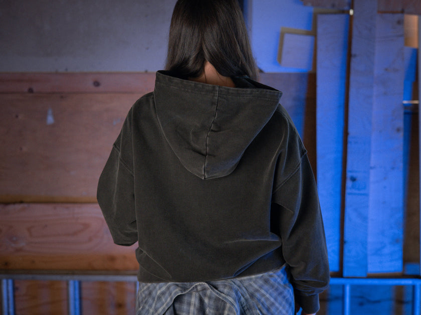 Rusty Quill X Knock Thrice 100% cotton hoodie in black, with a boxy, oversized, slightly cropped fit. The hoodie features both printed and embroidered details.