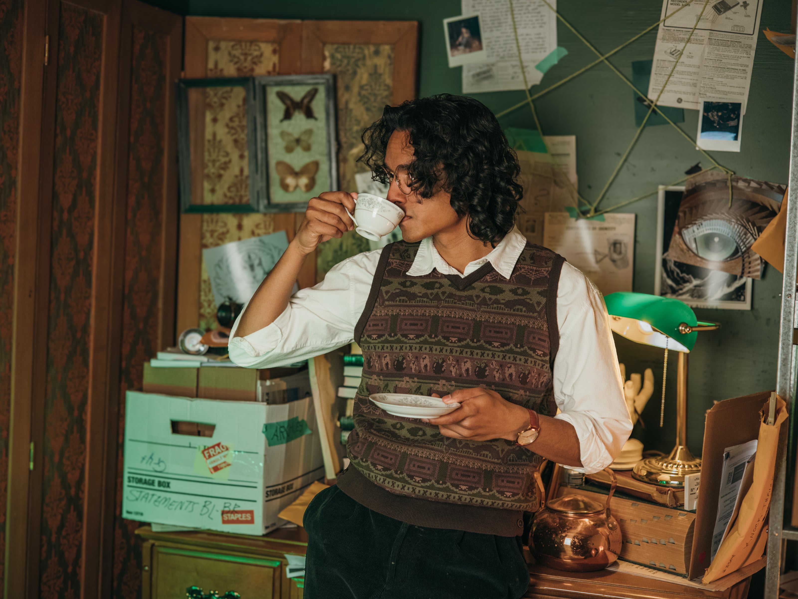 Magnus Archives x Knock Thrice knitted v-neck vest in dark green brown, and burgundy, made of 100% cotton.