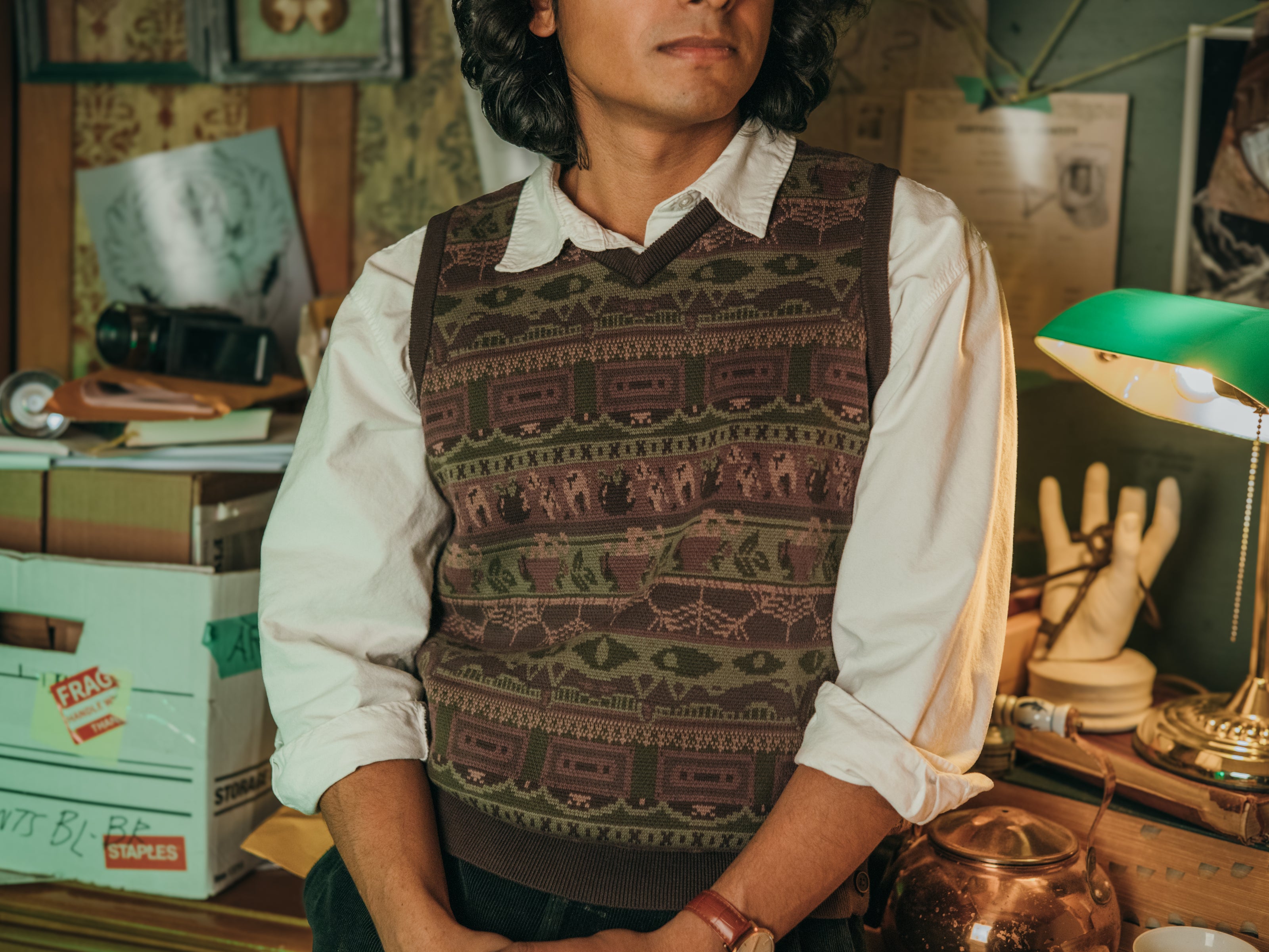 Magnus Archives x Knock Thrice knitted v-neck vest in dark green brown, and burgundy, made of 100% cotton.