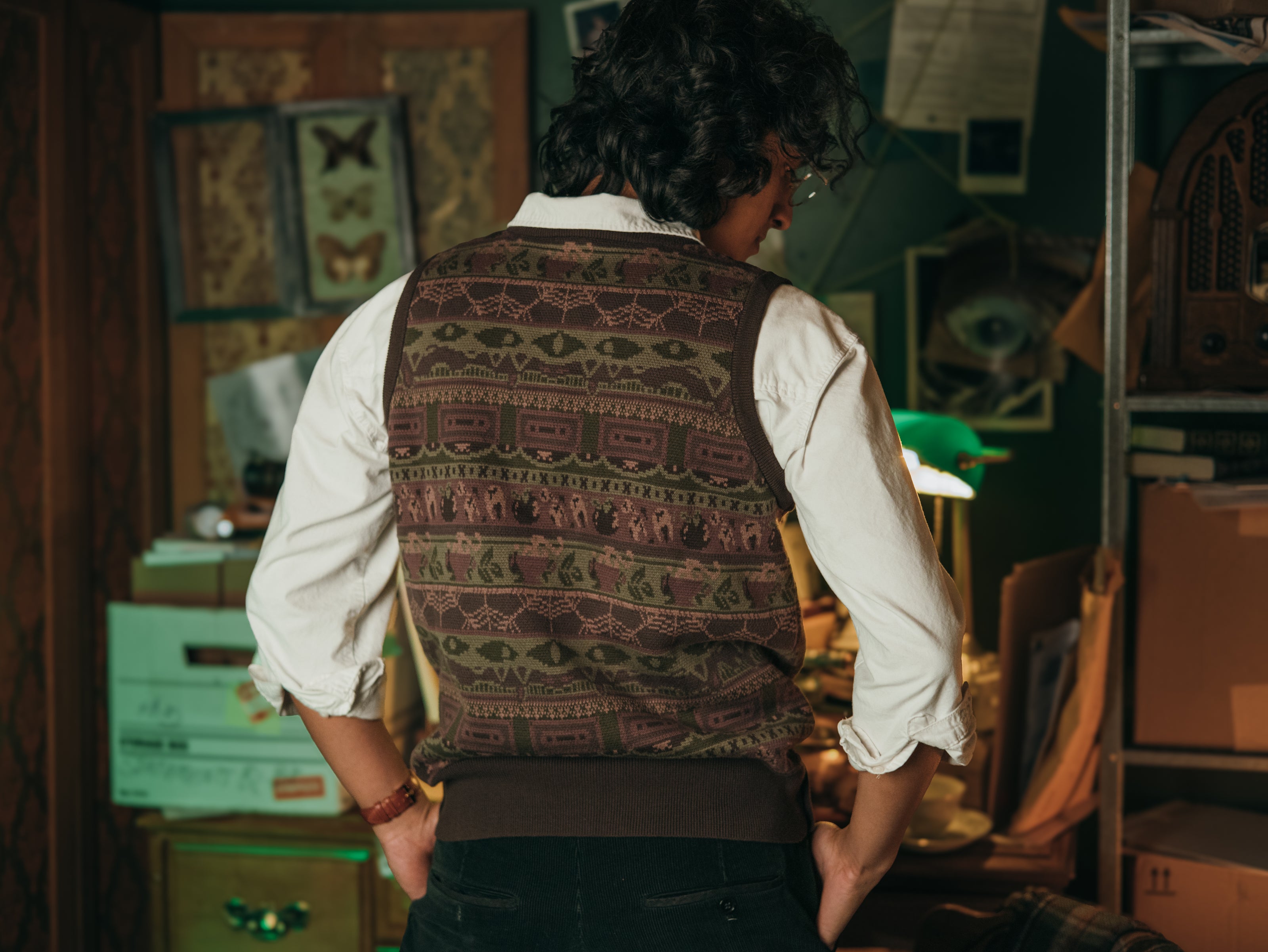 Magnus Archives x Knock Thrice knitted v-neck vest in dark green brown, and burgundy, made of 100% cotton.