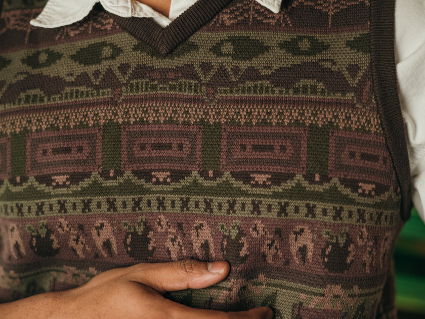 Magnus Archives x Knock Thrice knitted v-neck vest in dark green brown, and burgundy, made of 100% cotton.
