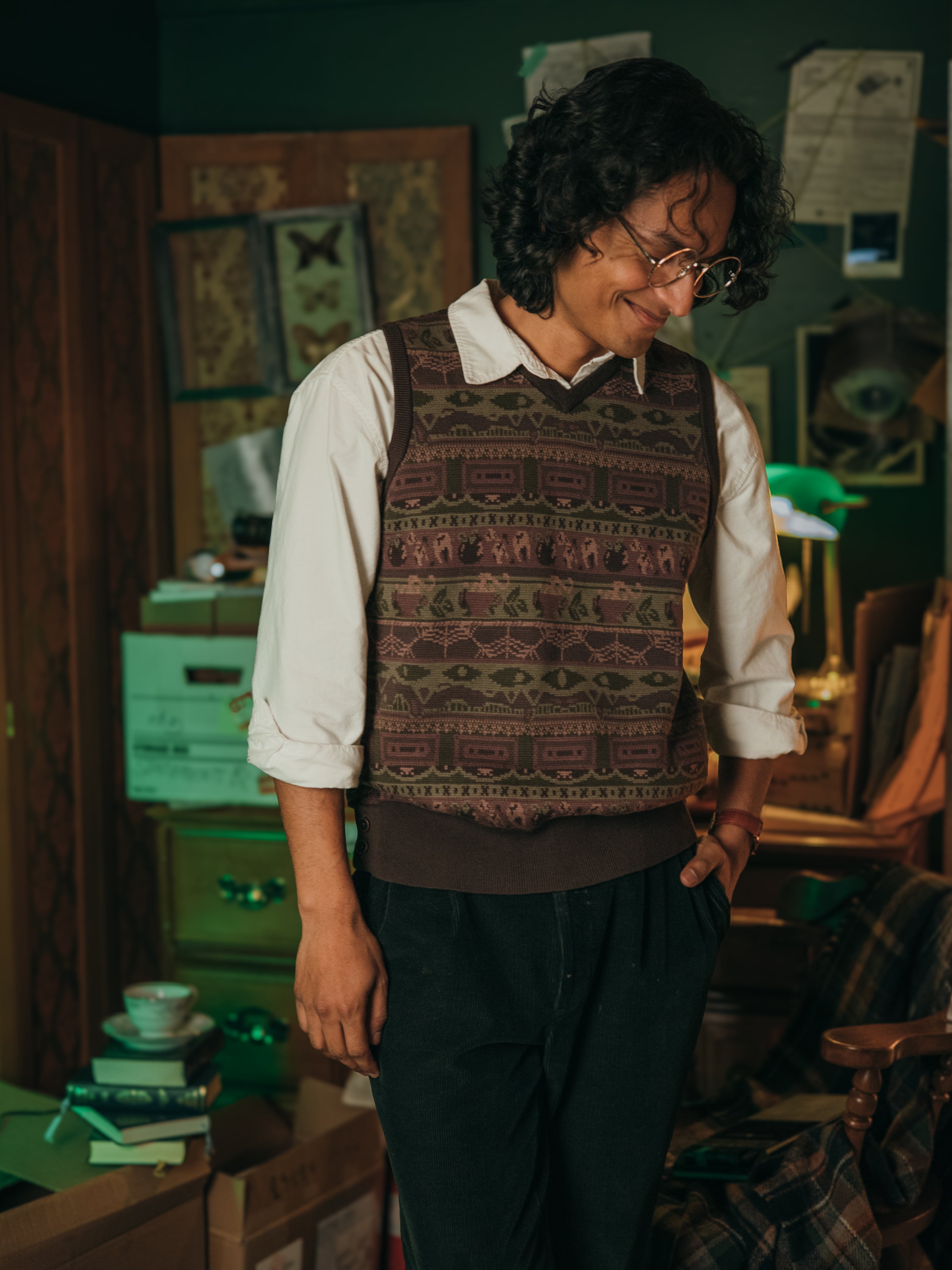Magnus Archives x Knock Thrice knitted v-neck vest in dark green brown, and burgundy, made of 100% cotton.