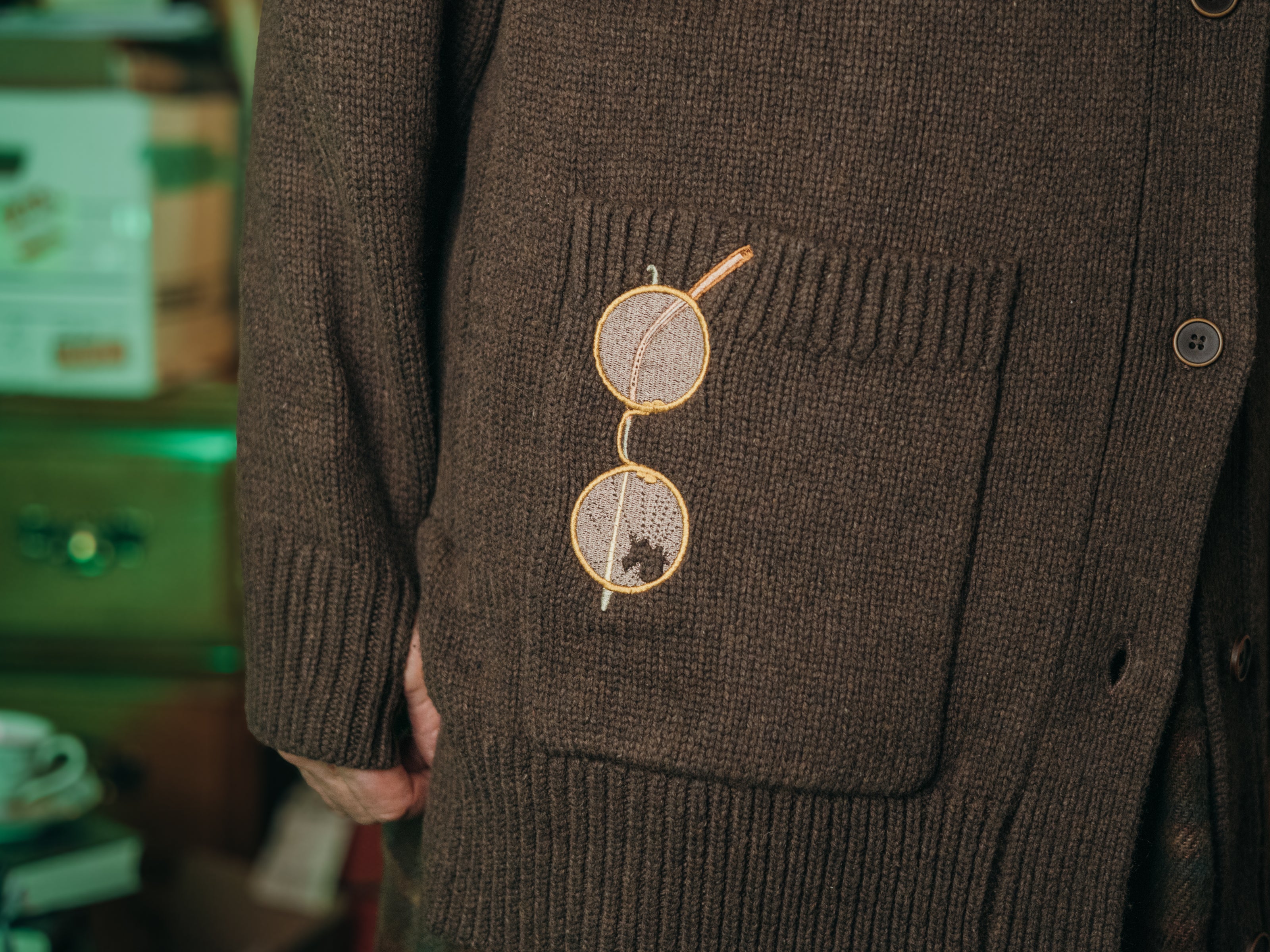 Magnus Archives x Knock Thrice oversized knit cardigan with embroidered details in dark brown. Made of 60% Cotton 30% Nylon 10% Wool.