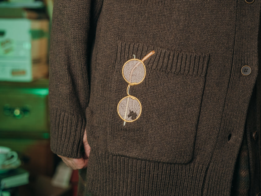 Magnus Archives x Knock Thrice oversized knit cardigan with embroidered details in dark brown. Made of 60% Cotton 30% Nylon 10% Wool.