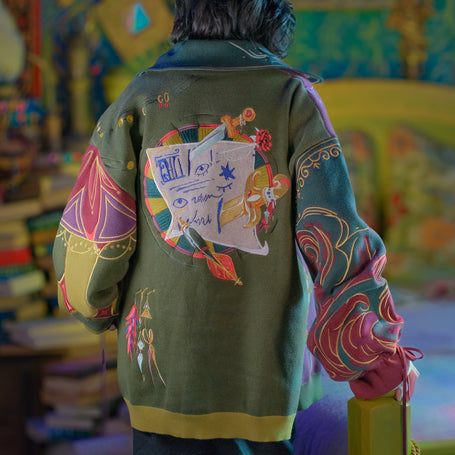 100% cotton, drop shoulder cardigan, featuring an oversized fit, drawstring sleeves, and colourful embroidered details.